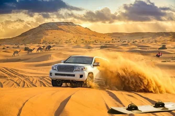 4x4 Land Cruiser dune bashing at sunset in the Dubai desert